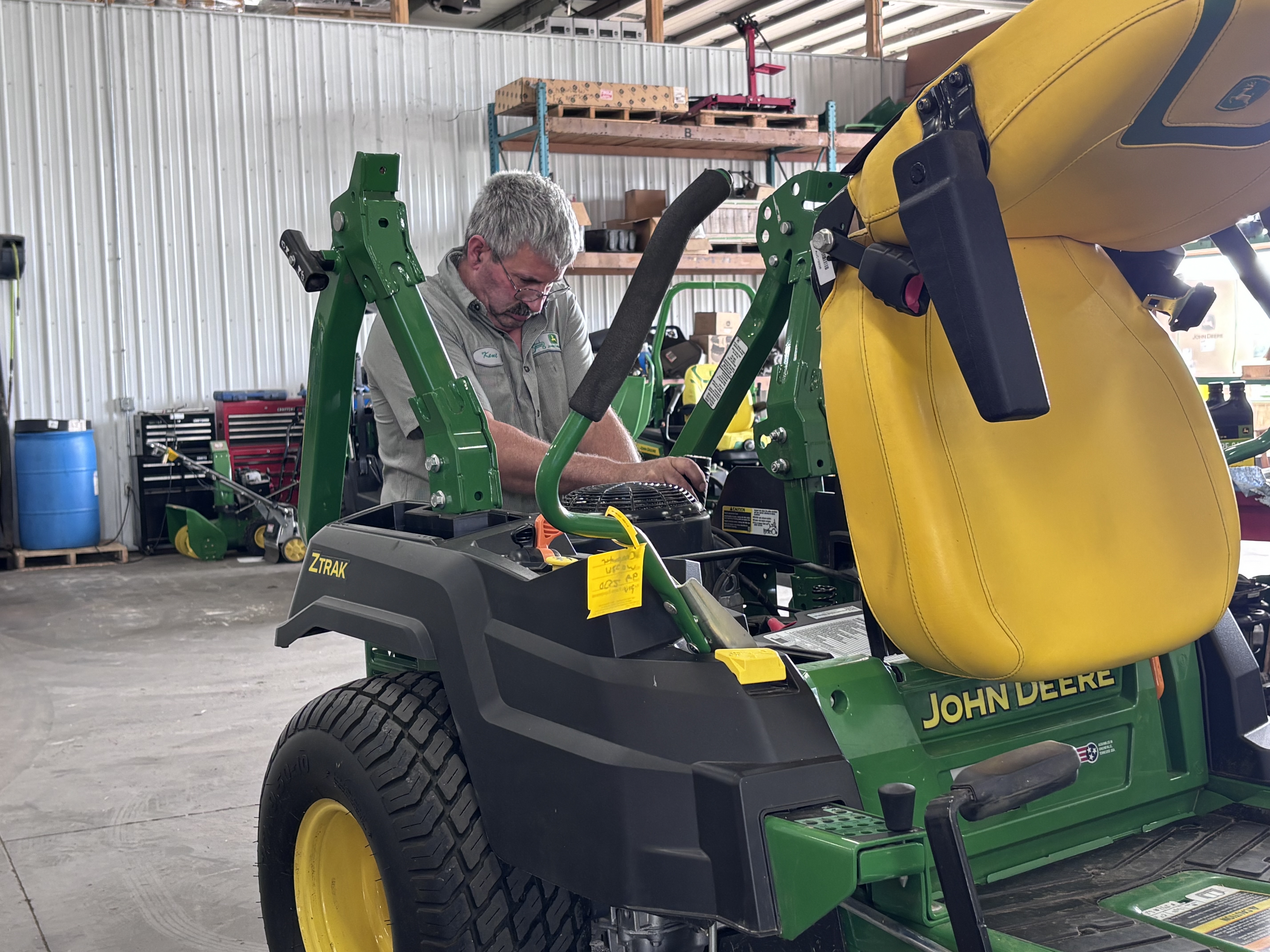 Reynolds technician servicing a residential zero-turn mower