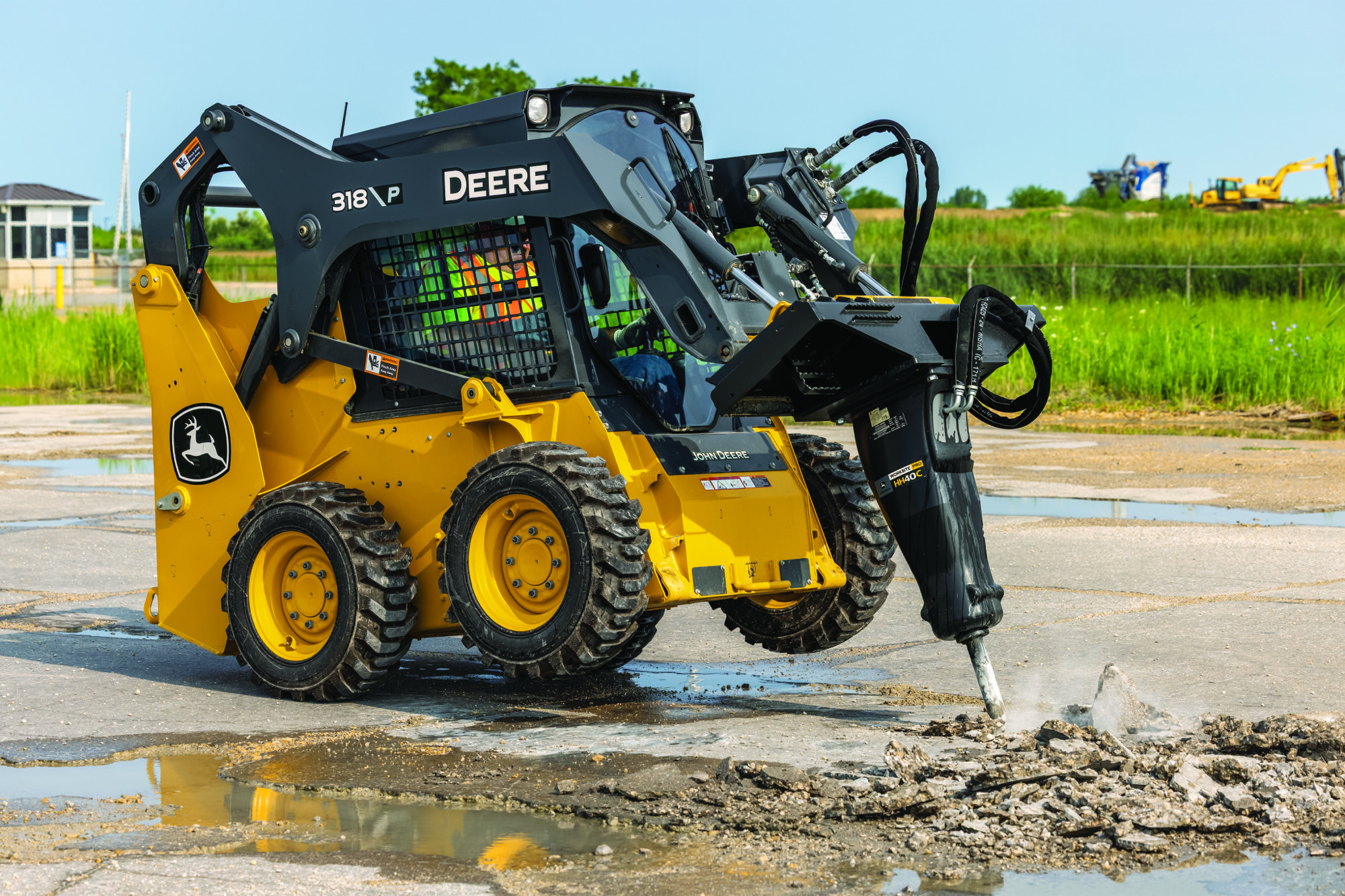 John Deere 318 P-Tier skid steer working on a United States jobsite