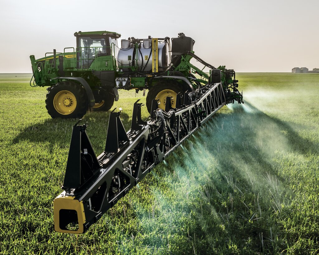 John Deere sprayer working in a green field