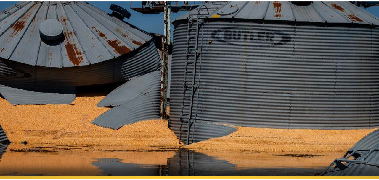 A picture of torn grainbins with crop spilling out. The image is just one of many farms that have flood affected midwest corn.